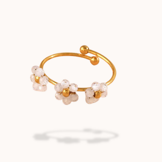 Gold ring with floral designs on a white background