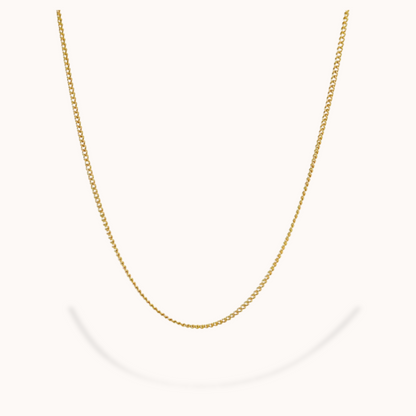 Gold chain necklace on a white background