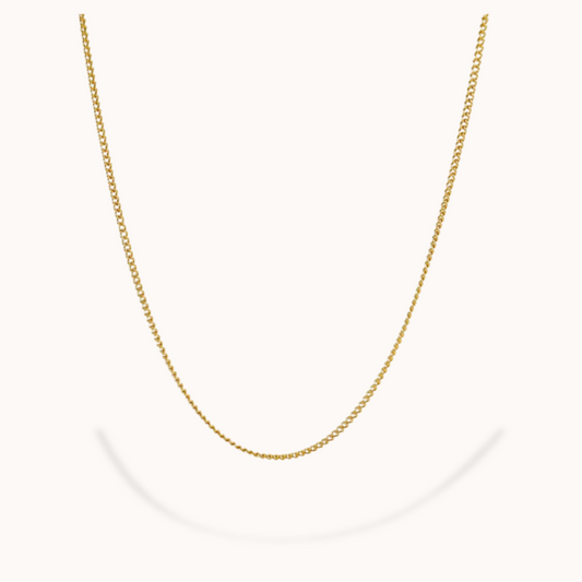 Gold chain necklace on a white background