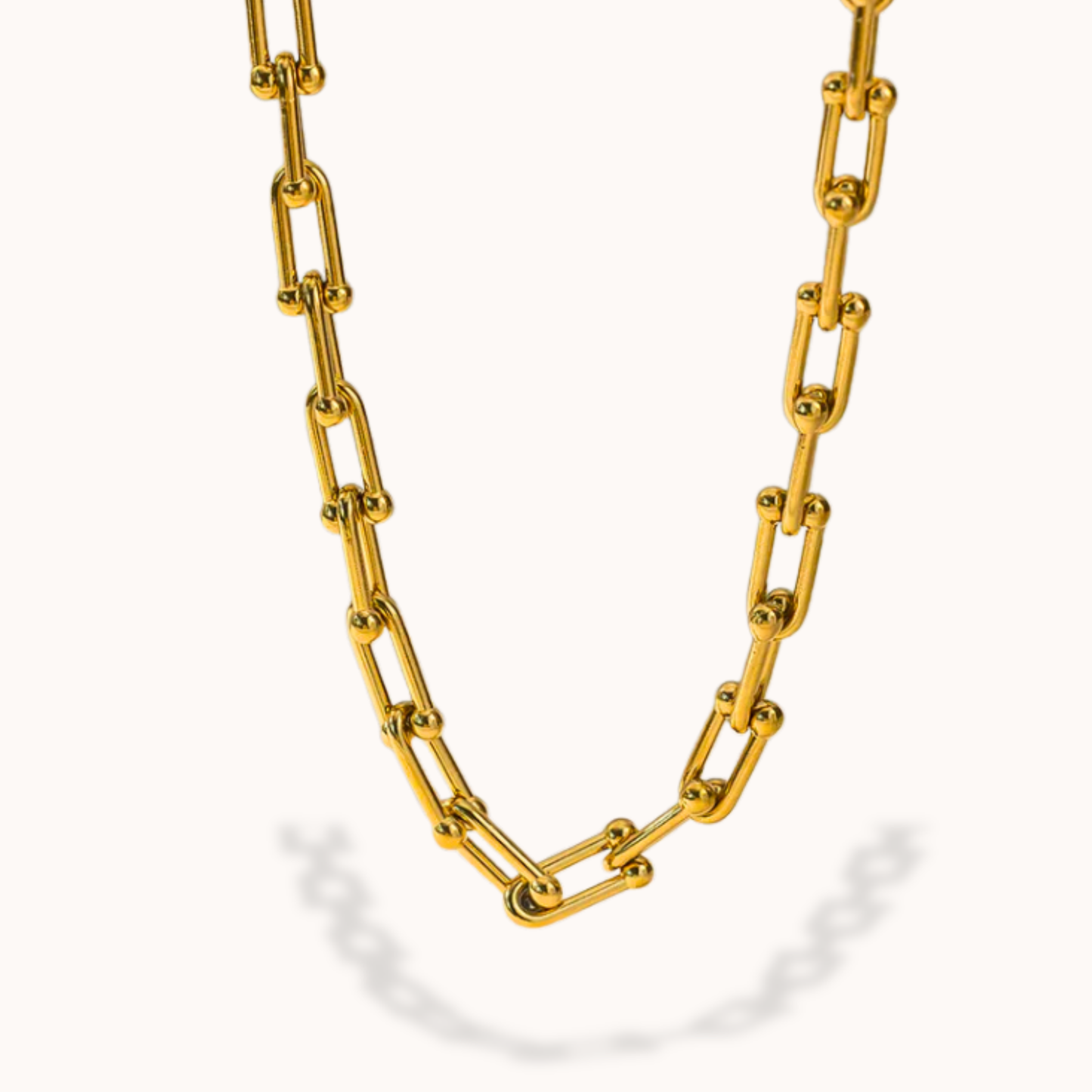 Gold chain necklace on a white background