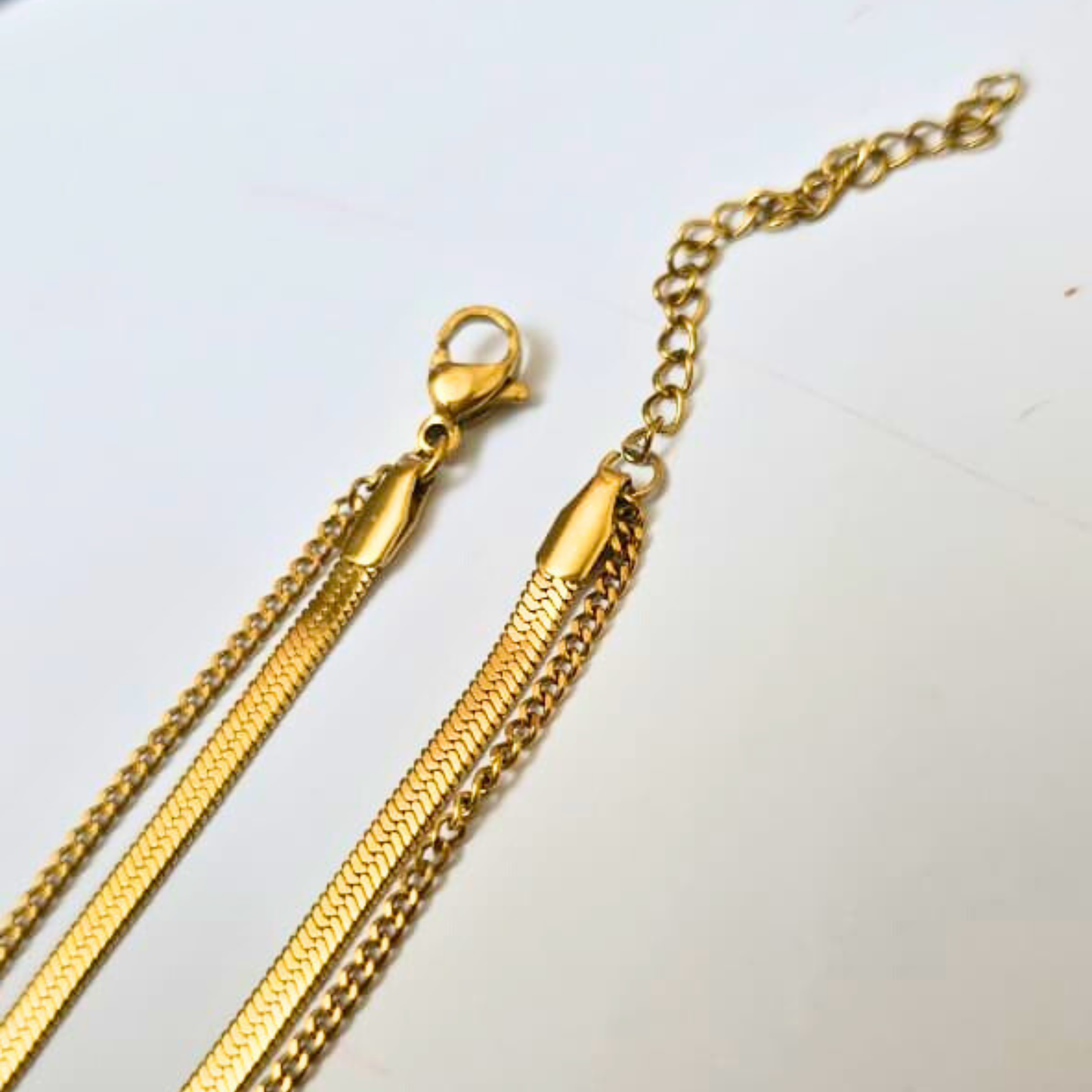 Gold chain necklace on a white background