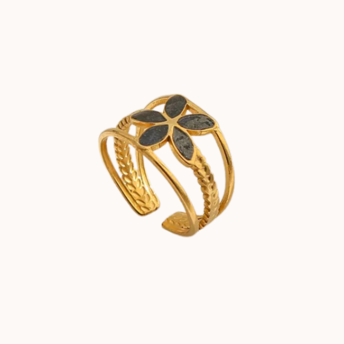 Gold bracelet with black floral designs on a white background