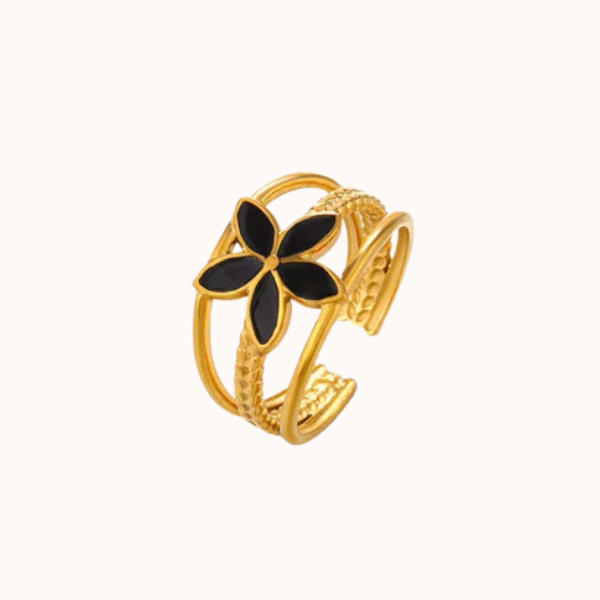 Gold bracelet with black flower design on a white background
