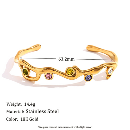 Gold bracelet with embedded gemstones on a white background