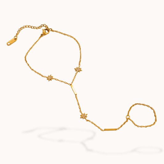 Gold chain bracelet with star-shaped links on a white background