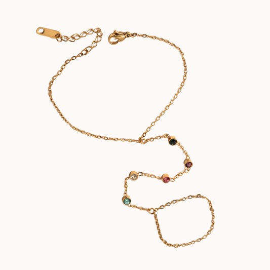 Gold bracelet with colorful beads on a white background