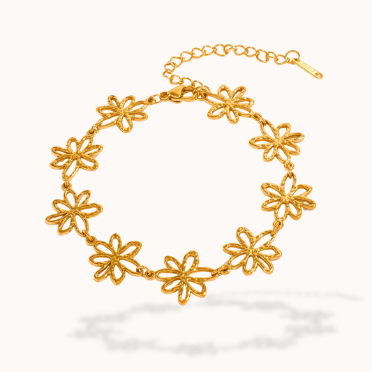 Gold floral bracelet on a white background