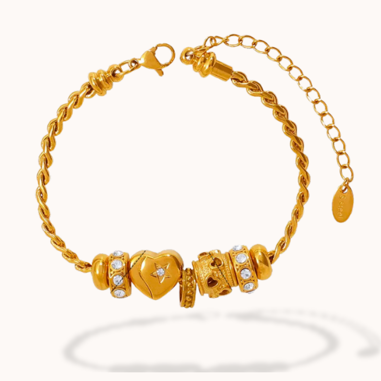 Gold bracelet with heart-shaped and round beads on a white background