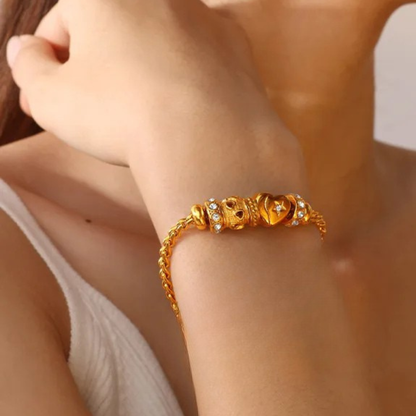Gold bracelet on a wrist with a blurred background