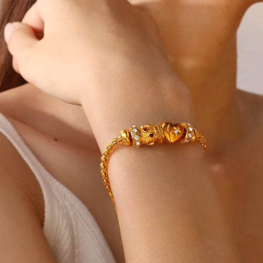 Gold bracelet on a wrist with a blurred background