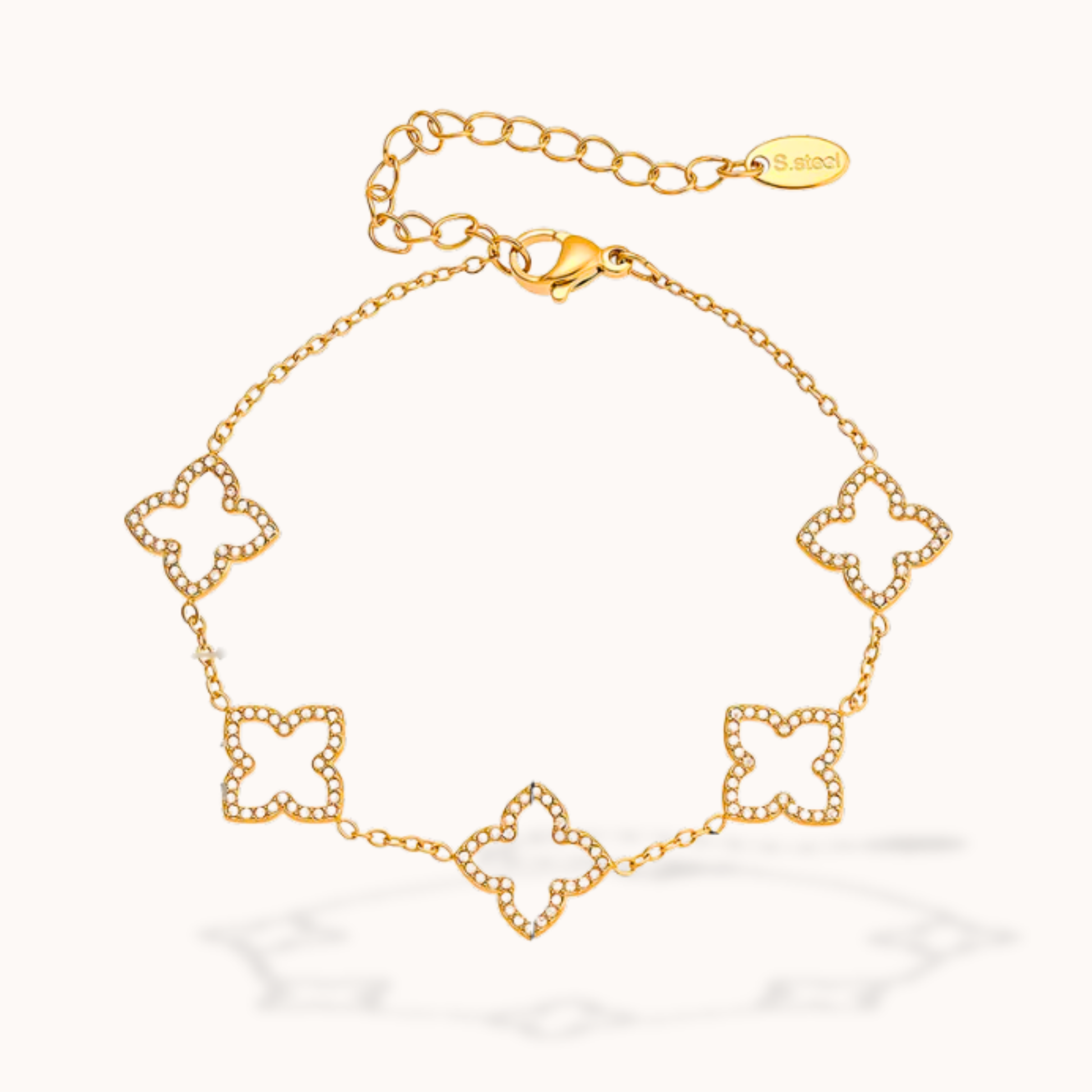 Gold bracelet with floral designs on a white background
