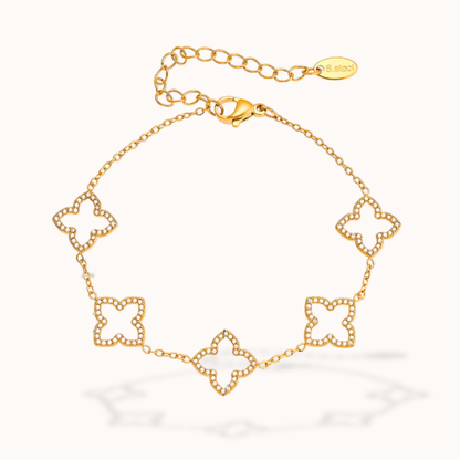 Gold bracelet with floral designs on a white background