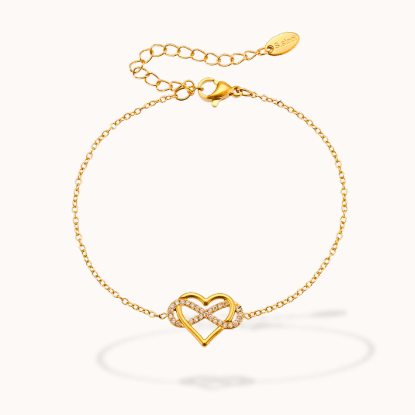 Gold bracelet with a heart-shaped clasp on a white background