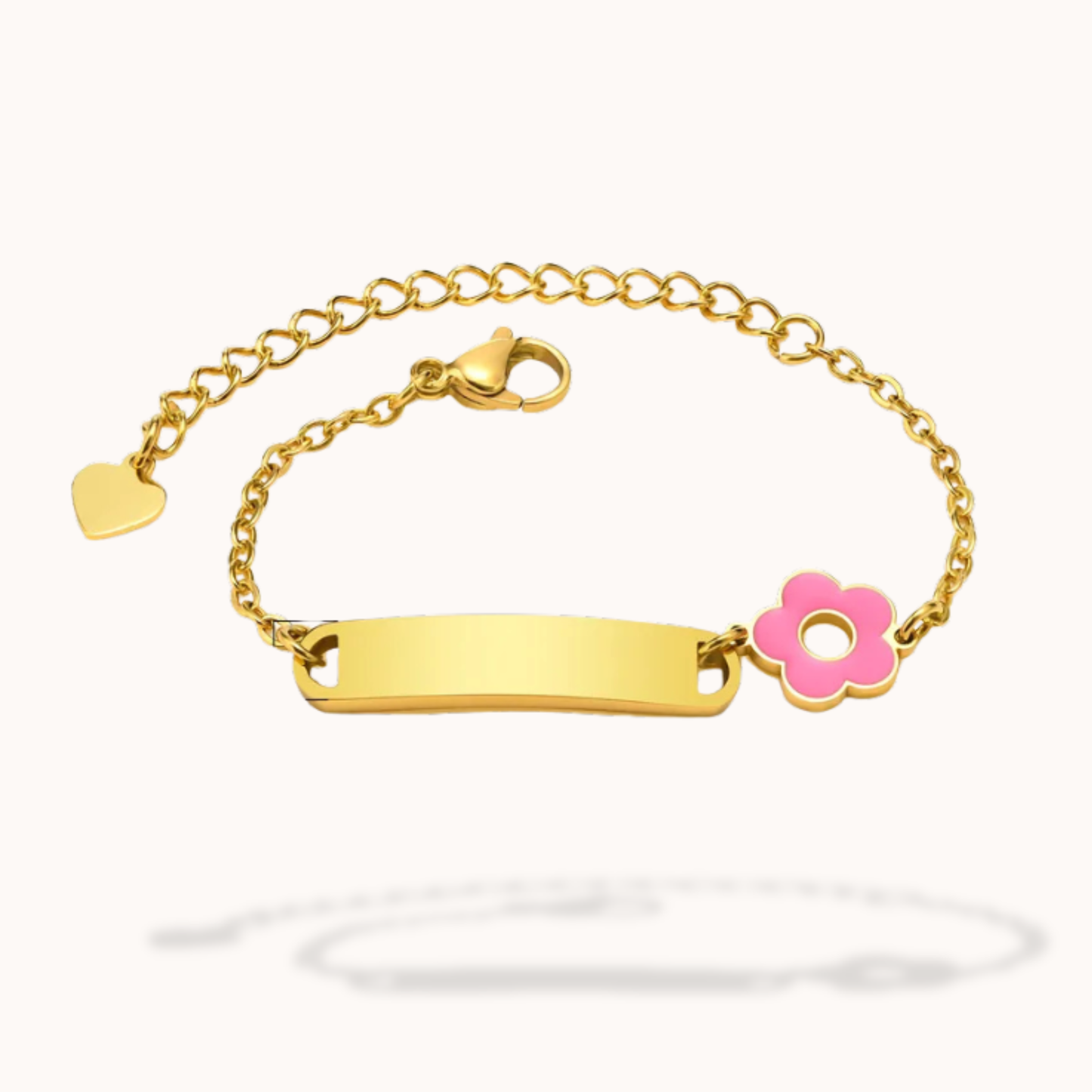Gold bracelet with a pink flower charm on a white background
