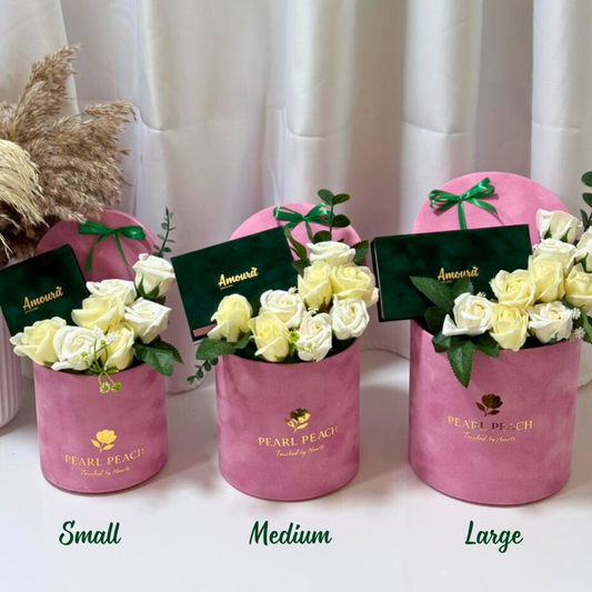 Three pink flower boxes labeled 'Small', 'Medium', and 'Large' with white flowers on a white background.