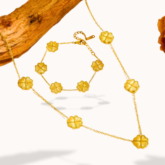 Gold necklace with floral designs on a white background