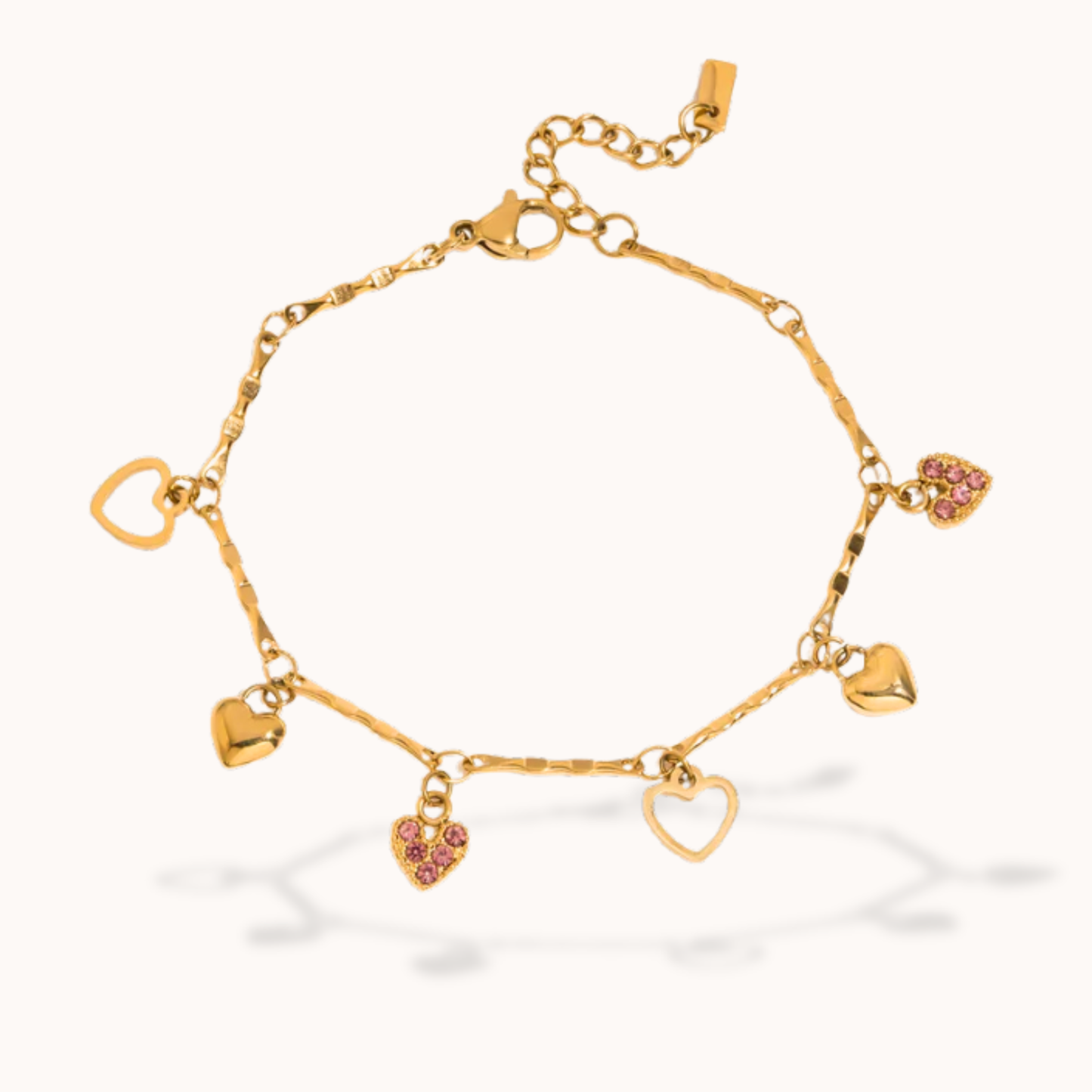 Gold bracelet with heart-shaped charms on a white background