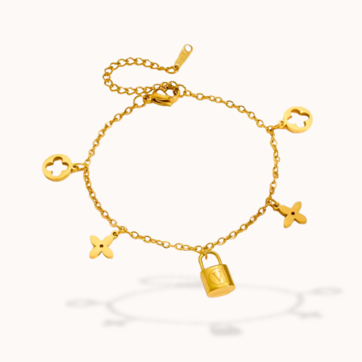 Gold bracelet with charms on a white background
