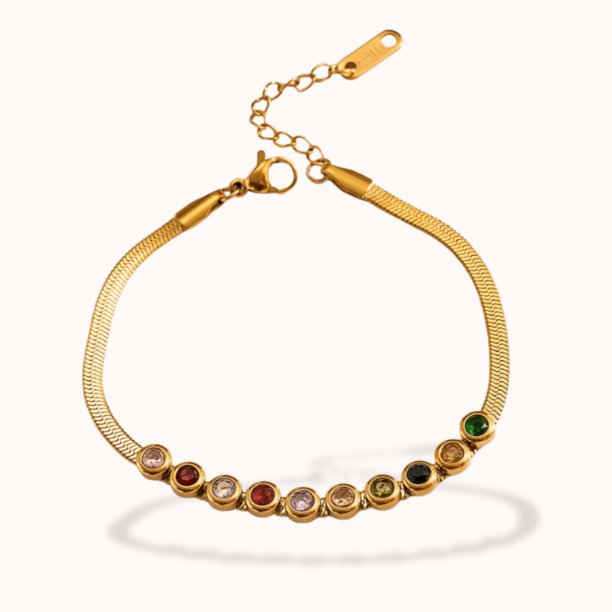 Gold bracelet with colorful gemstones on a white background