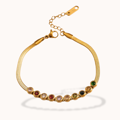 Gold bracelet with colorful gemstones on a white background