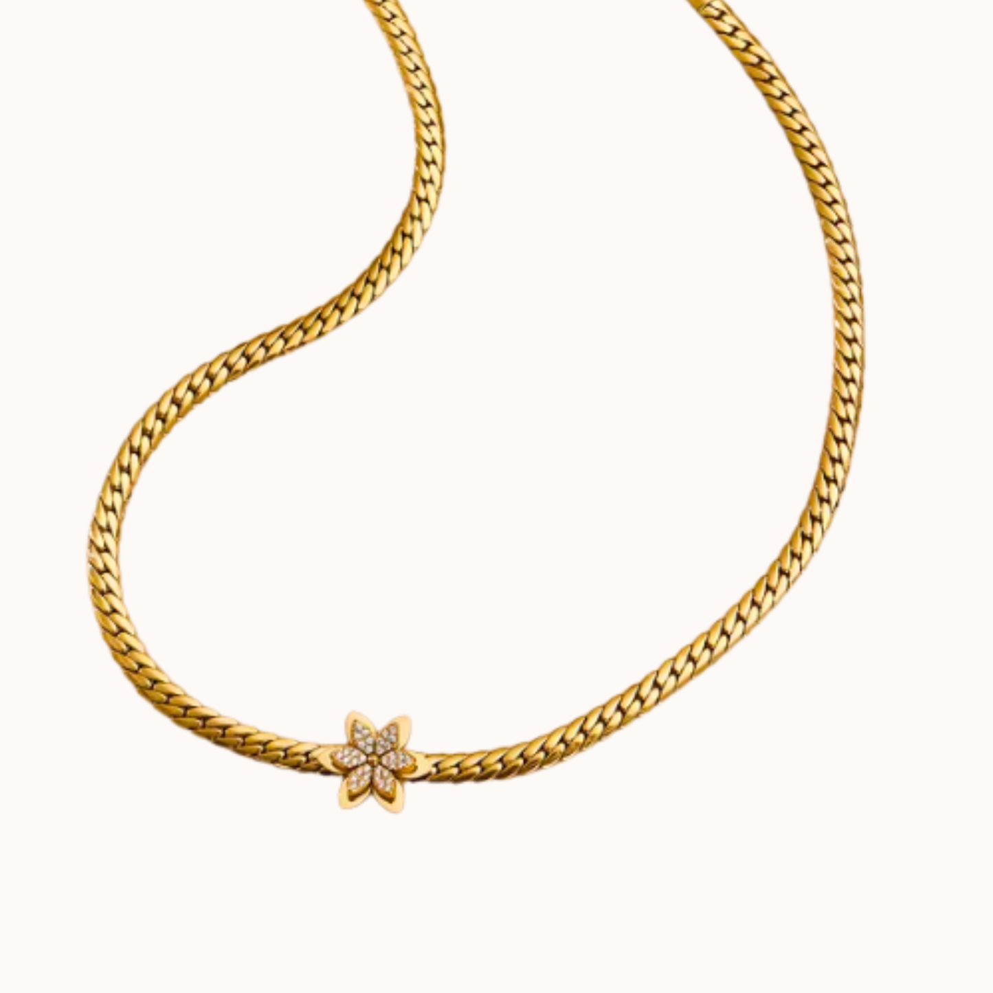 Gold chain necklace with a star-shaped clasp on a white background