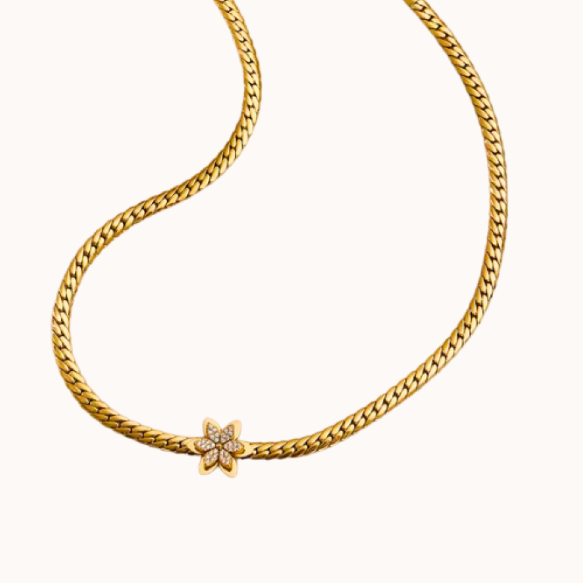 Gold chain necklace with a star-shaped clasp on a white background