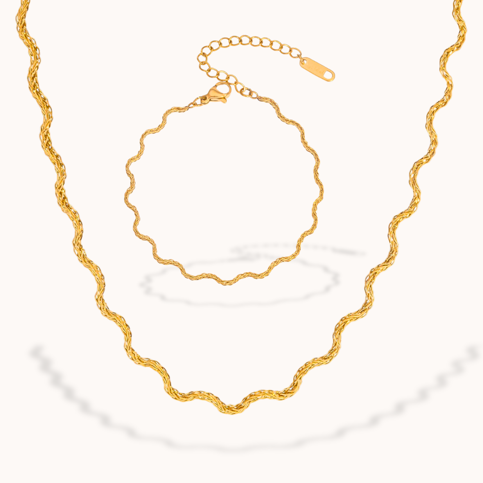 Gold necklace and bracelet on a white background