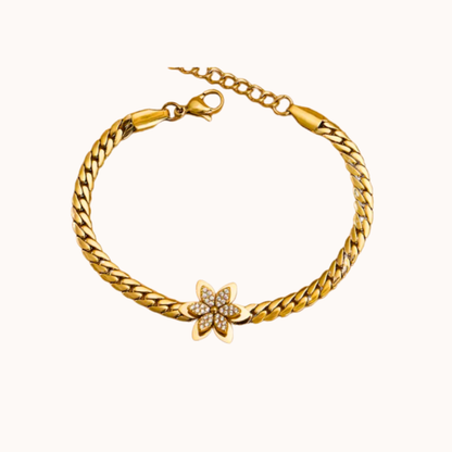 Gold bracelet with a starfish charm on a white background