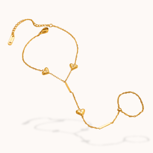 Gold bracelet with heart-shaped charms on a white background