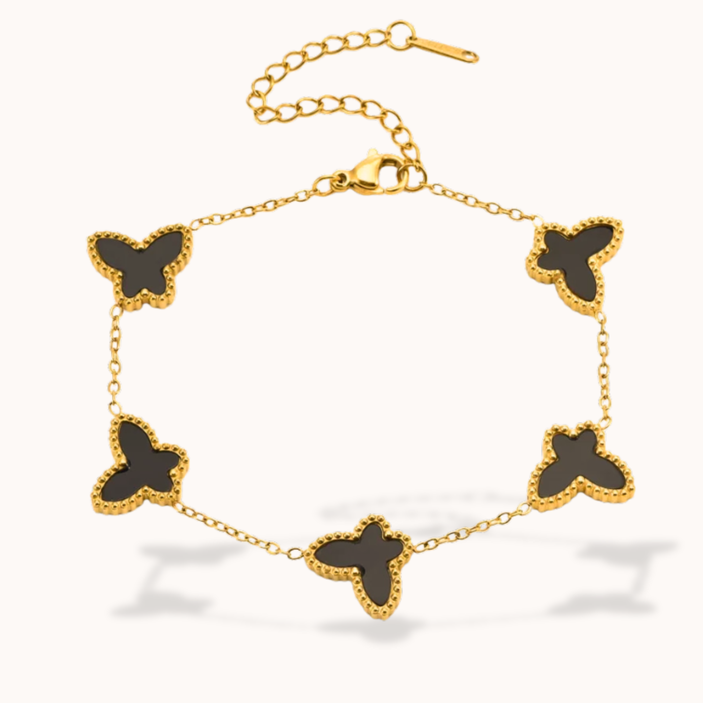 Gold bracelet with black butterfly charms on a white background