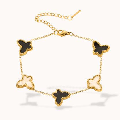 Gold bracelet with butterfly-shaped charms on a white background