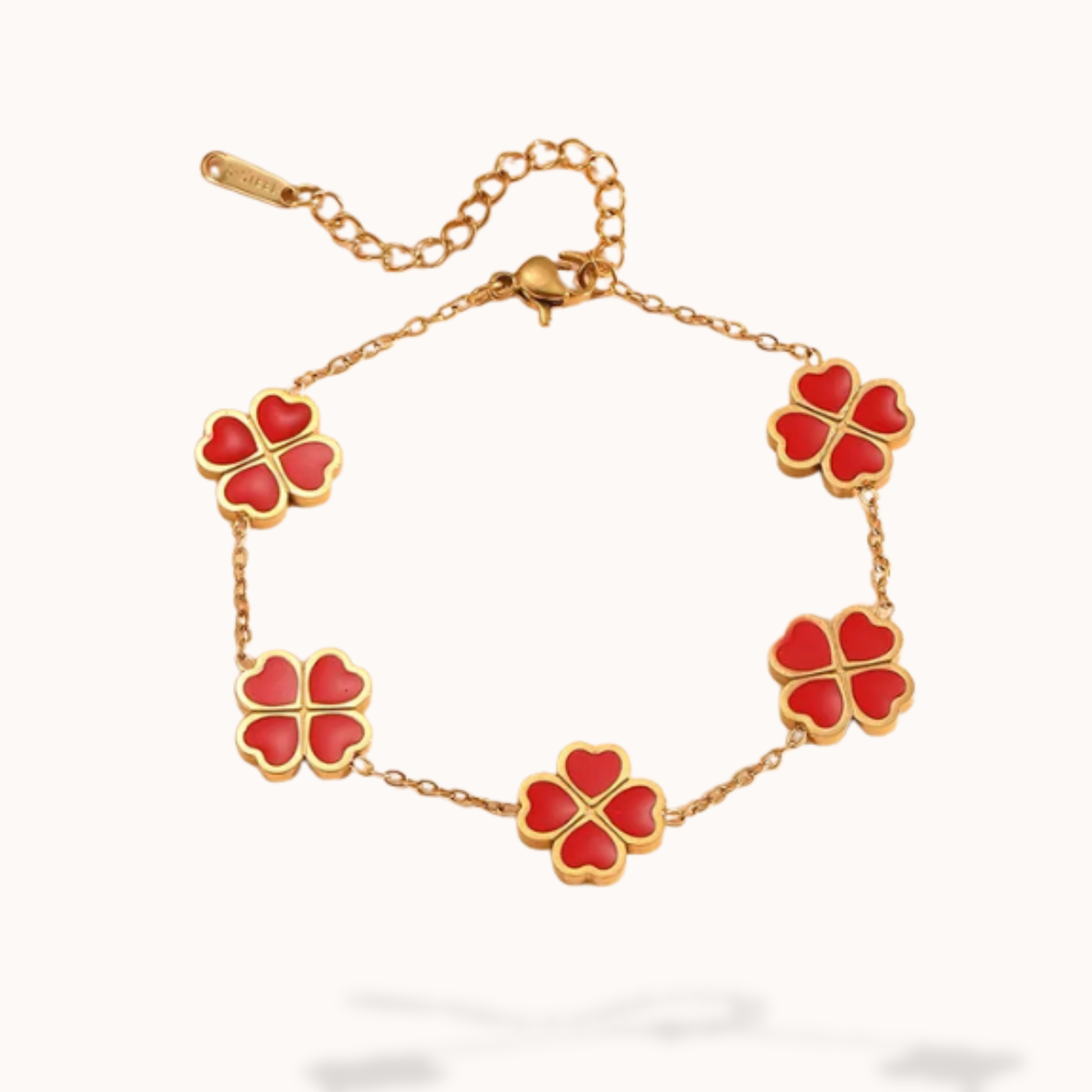 Gold bracelet with red clover-shaped charms on a white background