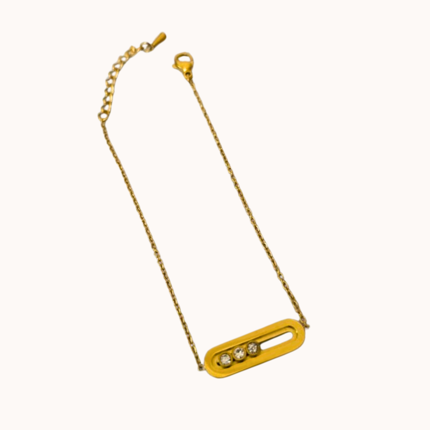 Gold necklace with a rectangular pendant on a white background