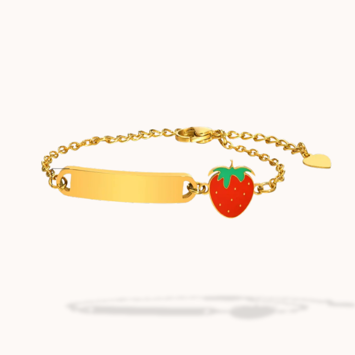 Gold bracelet with a strawberry charm on a white background