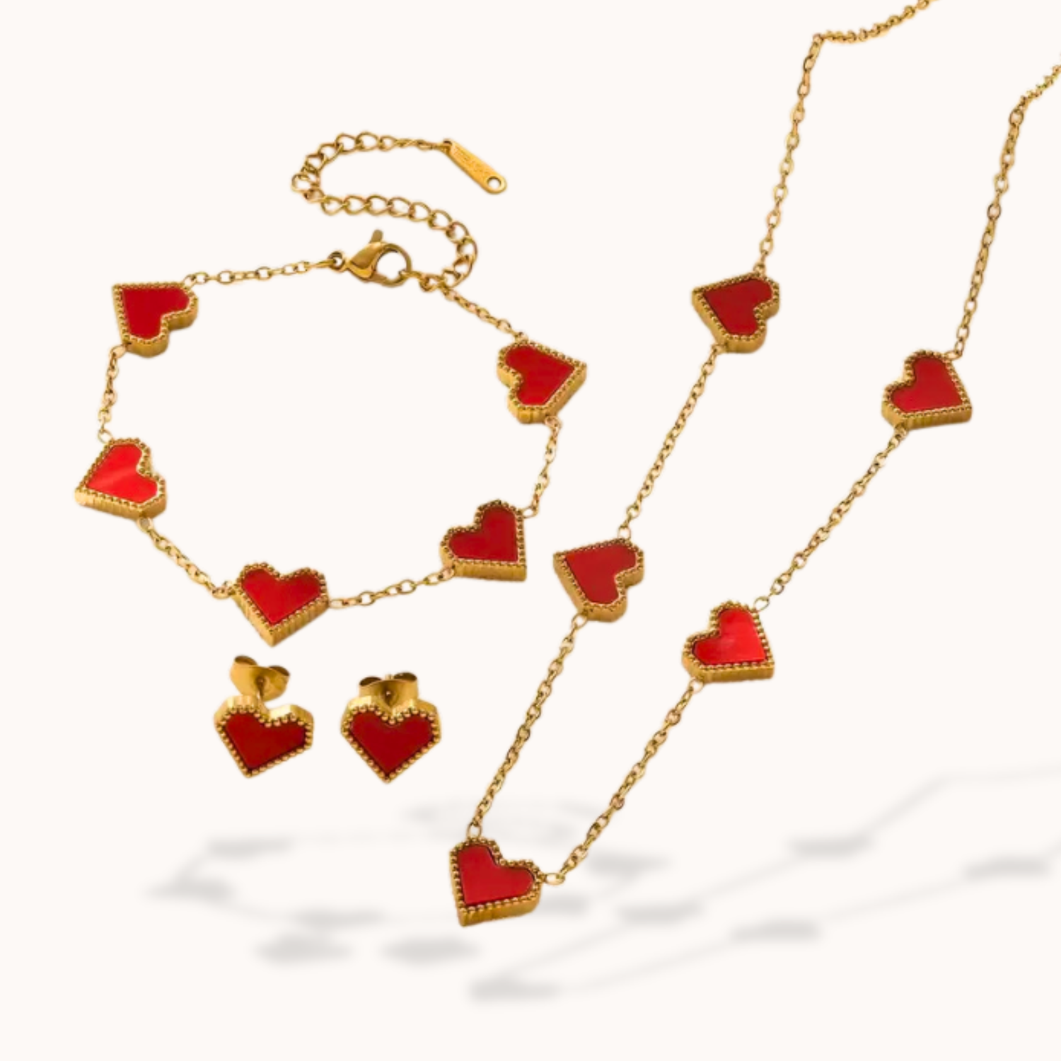 Jewelry set with red heart-shaped pendants on a gold chain
