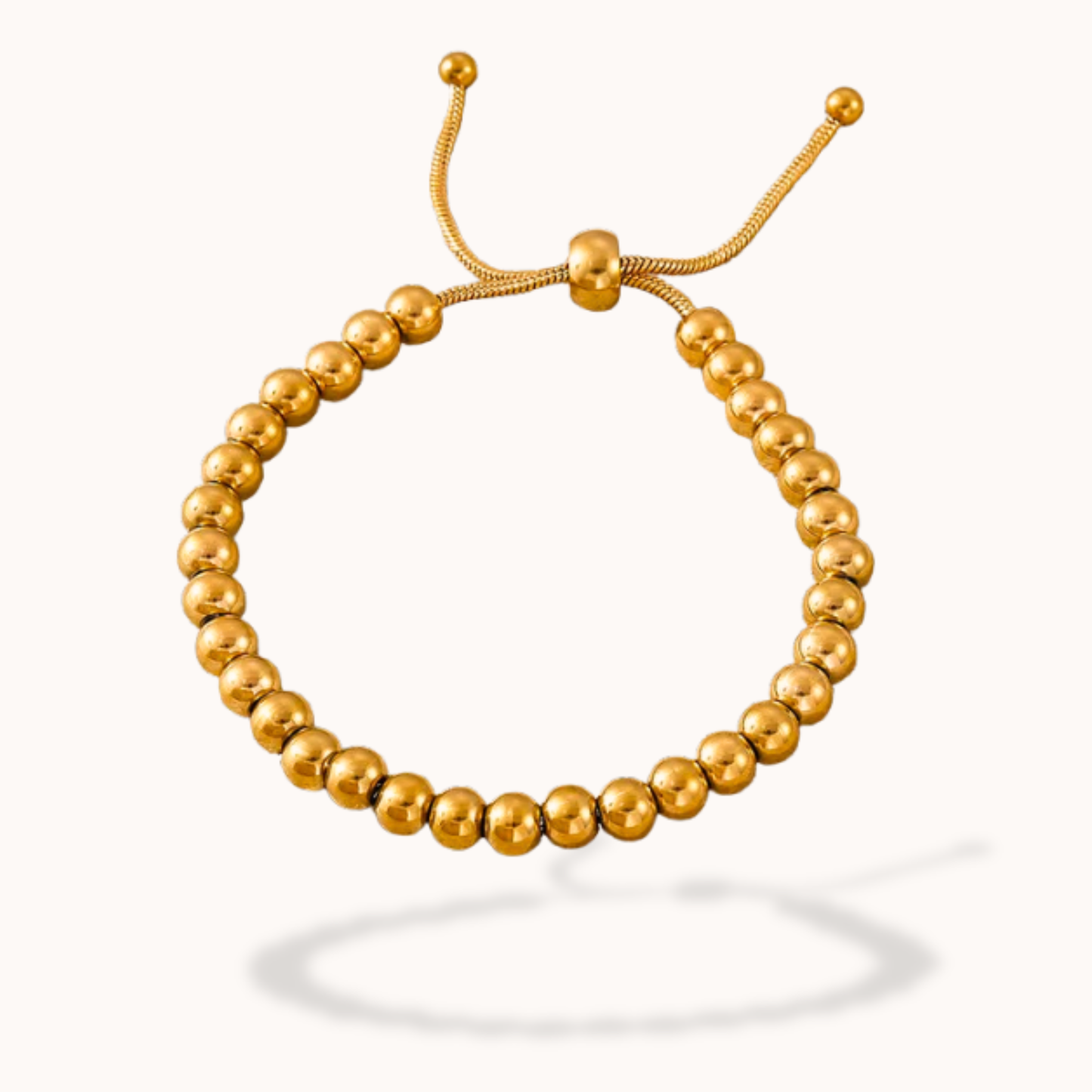 Gold beaded bracelet on a white background