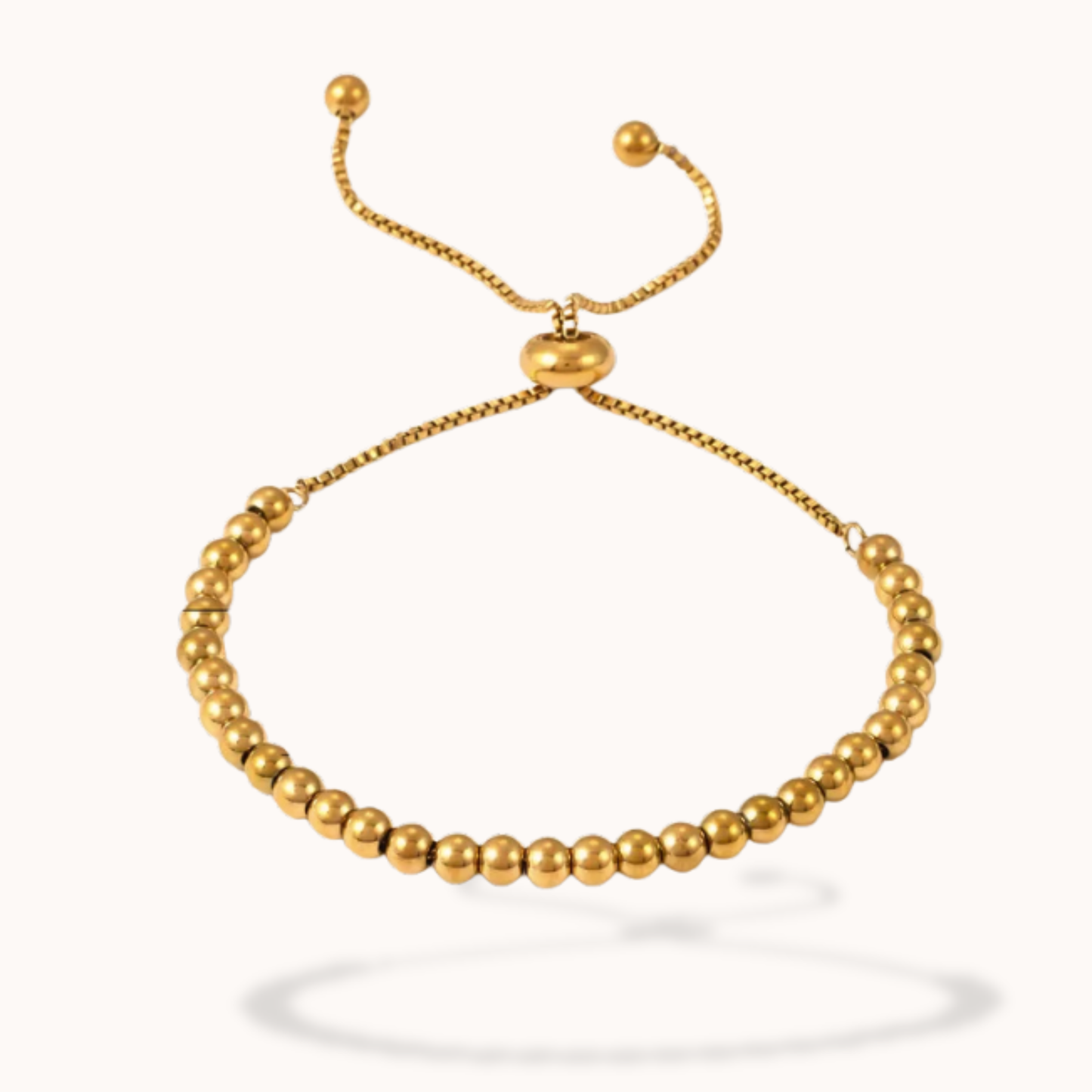 Gold beaded bracelet on a white background