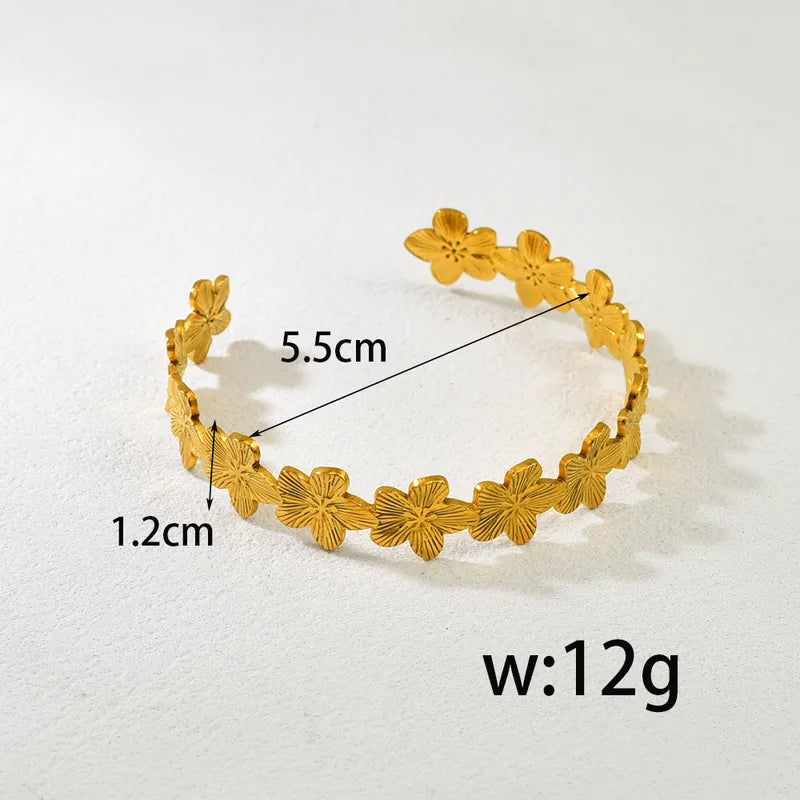 Gold bracelet with measurements on a white background