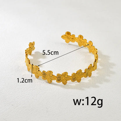 Gold bracelet with measurements on a white background