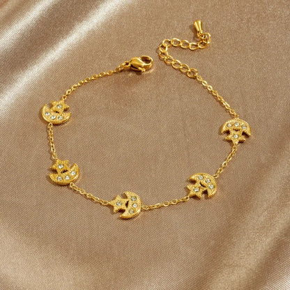 Gold bracelet with elephant designs on a beige fabric background
