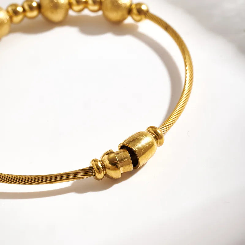 Gold bracelet with a clasp on a white background