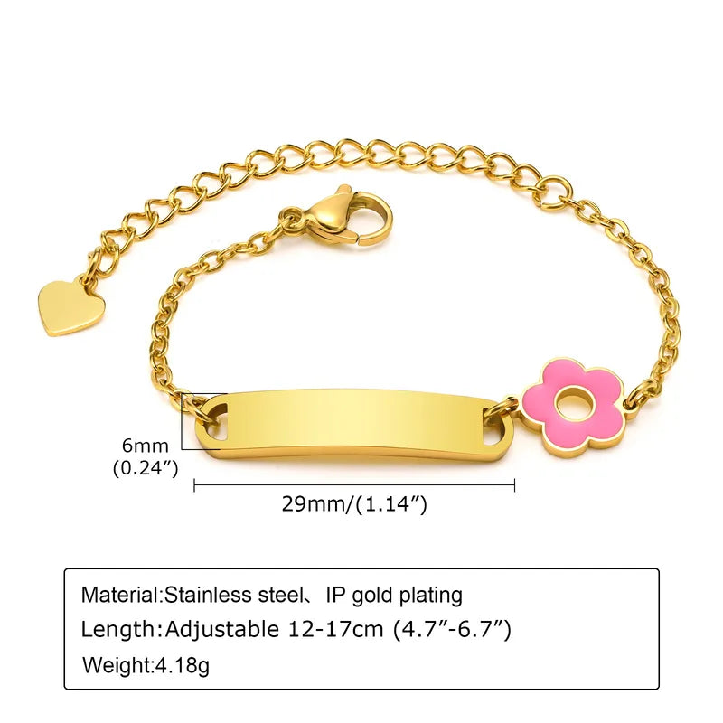 Gold bracelet with a pink flower charm on a white background