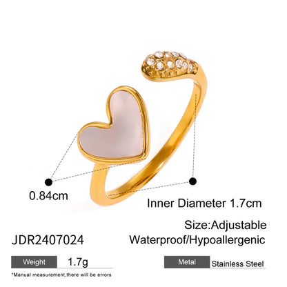Gold ring with heart-shaped pink stone and adjustable design on a white background