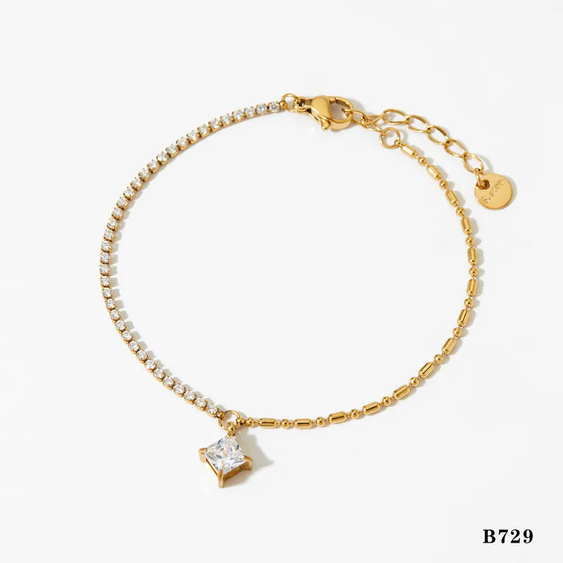 Gold bracelet with a star-shaped charm on a white background