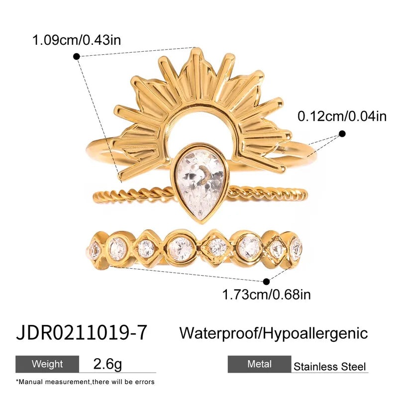 Gold ring with crystal heart design and measurements on a white background