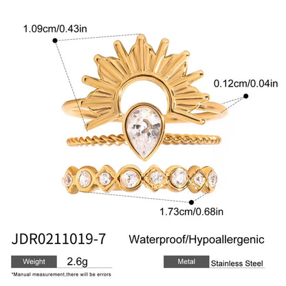 Gold ring with crystal heart design and measurements on a white background