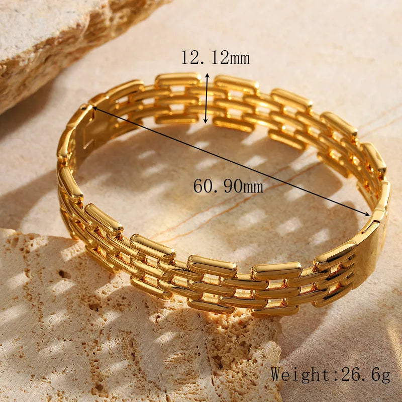 Gold bracelet with measurements on a textured surface