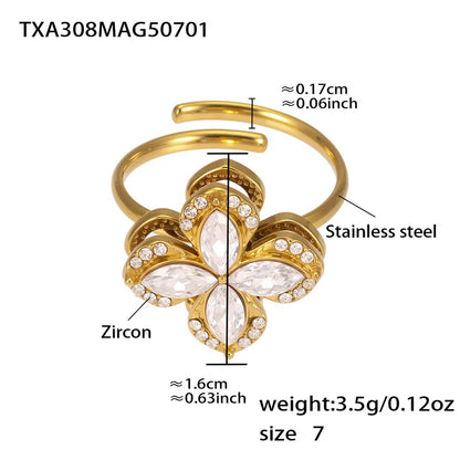 Gold butterfly-shaped ring with zircon and measurements on a white background
