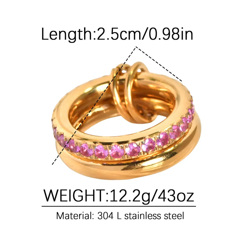 Gold ring with pink stones and measurements on a white background