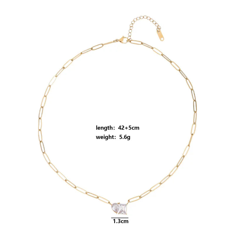 Gold chain necklace with a diamond pendant on a white background